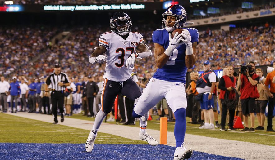 CORRECTS TO GIANTS' TJ JONES NOT ALDRICK ROSAS - New York Giants' TJ Jones, right, catches a pass for a touchdown against Chicago Bears defensive back John Franklin (37) during the second quarter of a preseason NFL football game Friday, Aug. 16, 2019, in East Rutherford, N.J. (AP Photo/Adam Hunger)