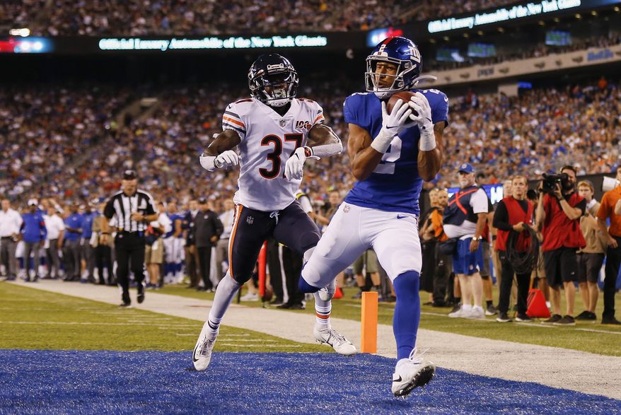 CORRECTS TO GIANTS' TJ JONES NOT ALDRICK ROSAS - New York Giants' TJ Jones, right, catches a pass for a touchdown against Chicago Bears defensive back John Franklin (37) during the second quarter of a preseason NFL football game Friday, Aug. 16, 2019, in East Rutherford, N.J. (AP Photo/Adam Hunger)