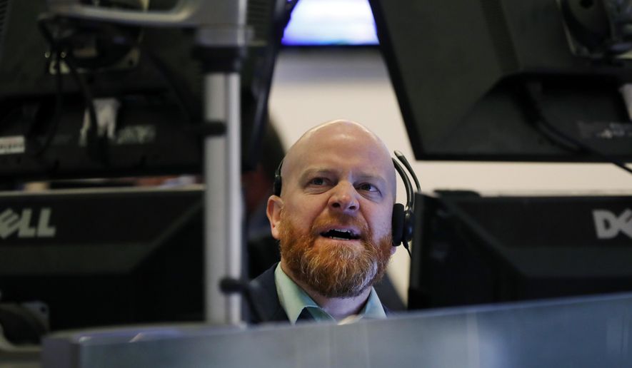 FILE - In this Aug. 13, 2019, file photo trader Steven Gohl monitors screens at his post on the floor of the New York Stock Exchange. The U.S. stock market opens at 9:30 a.m. EDT on Friday, Aug. 16. (AP Photo/Richard Drew, File)