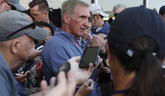 Retired NFL head coach Mike Shanahan, center, talks to reporters during a combined NFL training camp at which the Denver Broncos hosted the San Francisco 49ers Saturday, Aug. 17, 2019, at the Broncos&#39; headquarters in Englewood, Colo. (AP Photo/David Zalubowski)