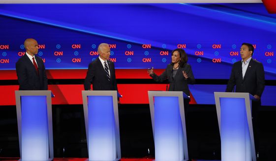 Sen. Cory Booker, D-N.J., from left, former Vice President Joe Biden, Sen. Kamala Harris, D-Calif., and Andrew Yang participate in the second of two Democratic presidential primary debates hosted by CNN, July 31, 2019, in the Fox Theatre in Detroit. (AP Photo/Paul Sancya) ** FILE **