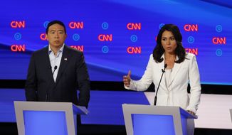 Andrew Yang, Rep. and Tulsi Gabbard, D-Hawaii participate in the second of two Democratic presidential primary debates hosted by CNN, July 31, 2019, in the Fox Theatre in Detroit. (AP Photo/Paul Sancya)