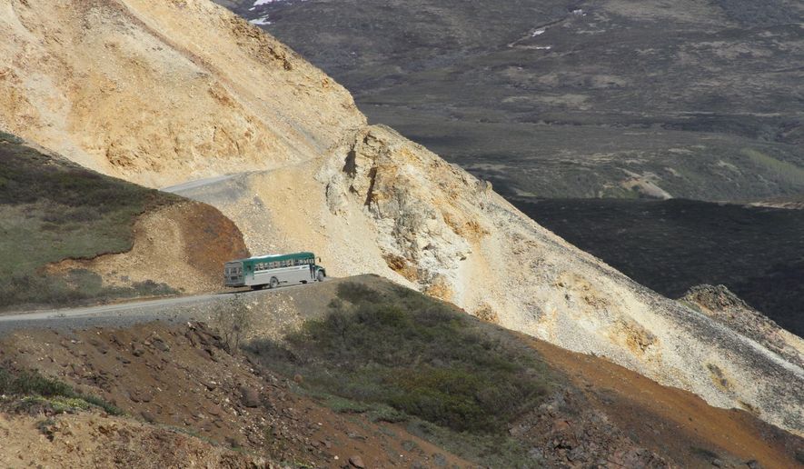 This May 27, 2016, photo shows a tourist bus near Polychome Pass on the only road inside Denali National Park and Preserve, Alaska. Park officials on Friday, Aug. 16, 2019, closed the park road at Mile 30 of the 92-mile road after a culvert washout and several mudslides in the area surrounding Polychome Pass and Eielson Visitor Center created unsafe conditions. Park officials say 300 tourists were inside the park, on the other side of the road closure (AP Photo/Mark Thiessen)