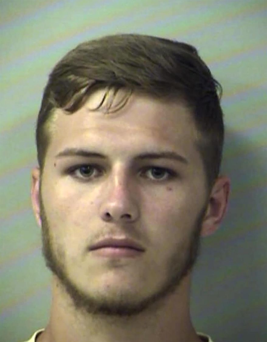 In this Thursday, Aug. 15, 2019, booking photo from the Okaloosa County Sheriff's Office shows Hunter Mills. Authorities say the Florida man used a front-end loader to dump a large bucket full of dirt on a car with his girlfriend was inside. The Okaloosa County Sheriff's Office says Mills was charged with felony criminal mischief. (Okaloosa County Sheriff's Office via AP)