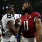 Oakland Raiders wide receiver Antonio Brown (84) and Arizona Cardinals wide receiver Larry Fitzgerald (11) meet at midfield after an an NFL preseason football game, Thursday, Aug. 15, 2019, in Glendale, Ariz. The Raiders won 33-26. (AP Photo/Rick Scuteri)
