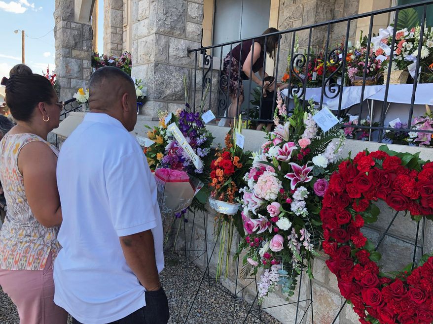 Mourners deliver flowers Friday for the funeral in El Paso, Texas, of Margie Reckard, 63, who was killed by a gunman in a mass shooting earlier in the month. Some mental health advocates say that the focus on people with mental illness is a distraction from solving gun violence in the U.S. (Associated Press)