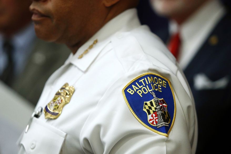 In this Aug. 29, 2018 file photo, a patch depicting the Baltimore Police Department seal is seen on Interim Commissioner Gary Tuggle&#x27;s uniform as he speaks at a news conference in Baltimore. The city has been casting for its fourth police leader in a year while the flailing department faces pressure to bring down violent crime levels that are among the nation&#x27;s worst. (AP Photo/Patrick Semansky, File)