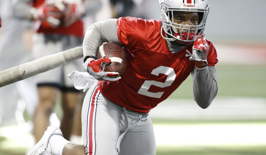 FILE - In this Wednesday, March 6, 2019 file photo, Ohio State running back J.K. Dobbins runs through a drill during an NCAA college football practice in Columbus, Ohio. J.K. Dobbins wants to make up for his “failure” last season. Despite rushing for over 1,000 yards, Dobbins calls 2018 a disappointment. He had a drop-off from his record-breaking freshman year and is determined to get back to that level and prove he’s best running back in the nation.(AP Photo/Paul Vernon, File)