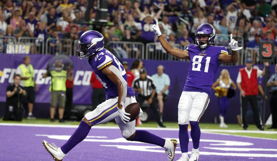 Minnesota Vikings tight end Irv Smith celebrates with teammate Bisi Johnson (81) after catching a 3-yard touchdown pass during the first half of an NFL preseason football game against the Seattle Seahawks, Sunday, Aug. 18, 2019, in Minneapolis. (AP Photo/Bruce Kluckhohn)