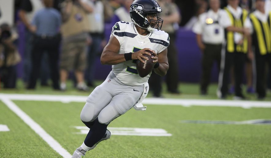 Seattle Seahawks quarterback Russell Wilson throws a pass during the first half of an NFL preseason football game against the Minnesota Vikings, Sunday, Aug. 18, 2019, in Minneapolis. (AP Photo/Jim Mone)