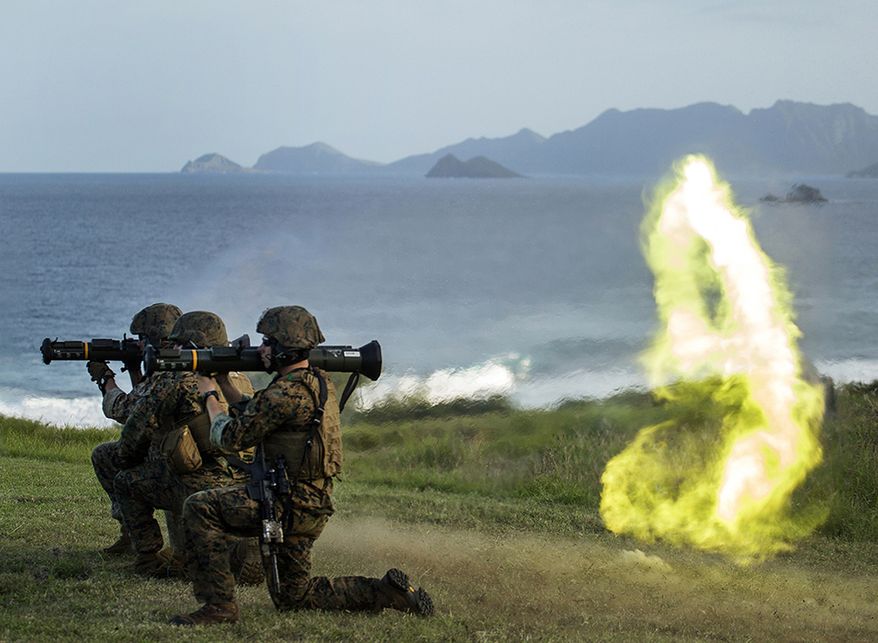 Sgt. Scott Hulsizer (left), a team leader with second platoon, Bravo Company, 3rd Reconnaissance Battalion, 3rd Marine Division, based in Okinawa, Japan, fires an M136 AT-4 rocket launcher after breaking away from the firing line as part of a weapons training package on the Kaneohe Bay Range Training Facility, March 4, 2014. 3rd Recon Bn. fired multiple weapon systems, such as the .50 caliber M2 Browning heavy machine gun, MK-19 automatic grenade launcher and M136 AT-4 rocket launchers, as part of a two day weapons package for Exercise Sandfisher. The weapons package focused on increasing the platoon’s proficiency with each system on the battlefield. (U.S. Marine Corps photo by Lance Cpl. Matthew Bragg)