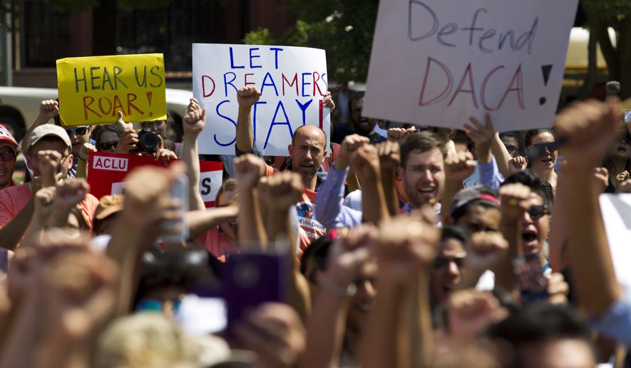 Protesters hold up signs during a rally supporting Deferred Action for Childhood Arrivals, or DACA, outside of the White House in Washington, on Tuesday, Sept. 5, 2017. (AP Photo/Jose Luis Magana) ** FILE **