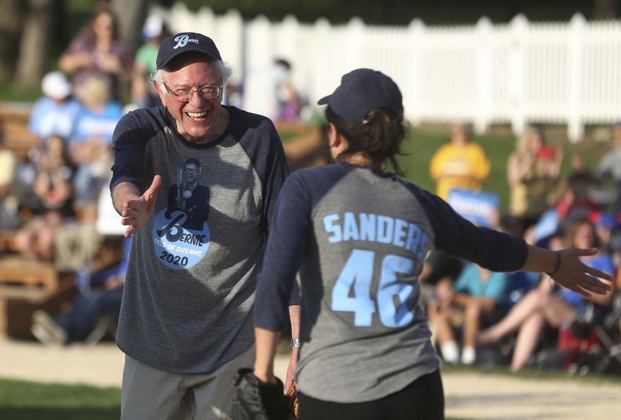 Democratic presidential candidate U.S. Sen. Bernie Sanders, I-Vt., cheers on his teammates before a softball game at the Field of Dreams in Dyersville, Iowa, Monday, Aug. 19, 2019. (Jessica Reilly/Telegraph Herald via AP)