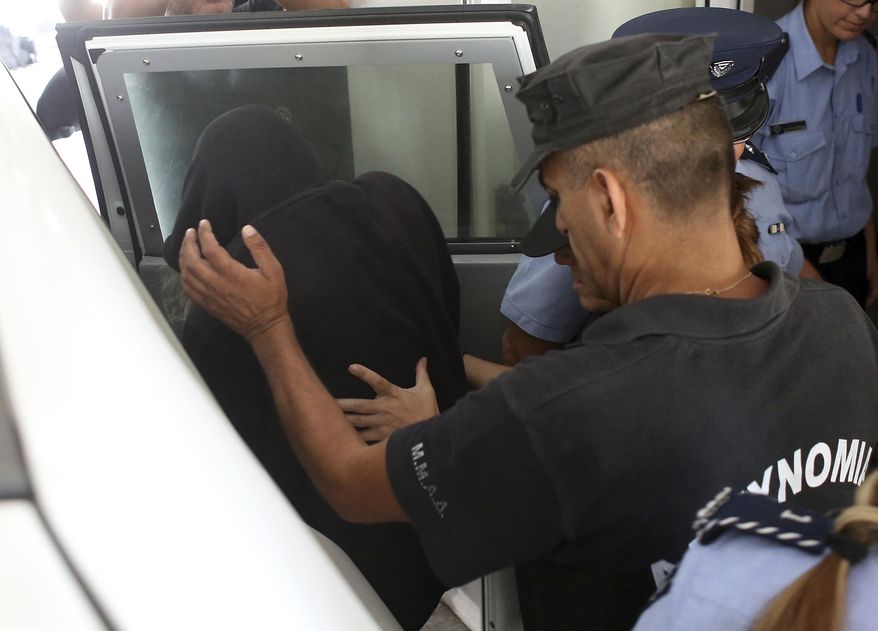 Elite police unit officers escort a 19-year old British woman, centre, with head covered, to Famagusta court in Paralimni, Cyprus, Monday, Aug. 19, 2019. A UK lawyer will join the new legal team representing a British teenager who faces a public nuisance charge for falsely accusing 12 Israelis of rape. A Cyprus district court judge on Monday approved request by a lawyer representing the 19 year-old British woman to adjourn proceedings until Aug. 27 in order to give the legal team time to review the case evidence and prepare their defense. (Photo/Philippos Christou)