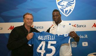 Brescia&#x27;s president Massimo Cellino, left, holds a soccer jersey with soccer player Mario Balotelli during a press conference, in Brescia, Italy, Monday, Aug. 19, 2019. Balotelli says his mother cried when he told her he was joining hometown club Brescia and insists he has no fear of failing on his return to Serie A after an absence of three years. (Filippo Venezia/ANSA via AP)