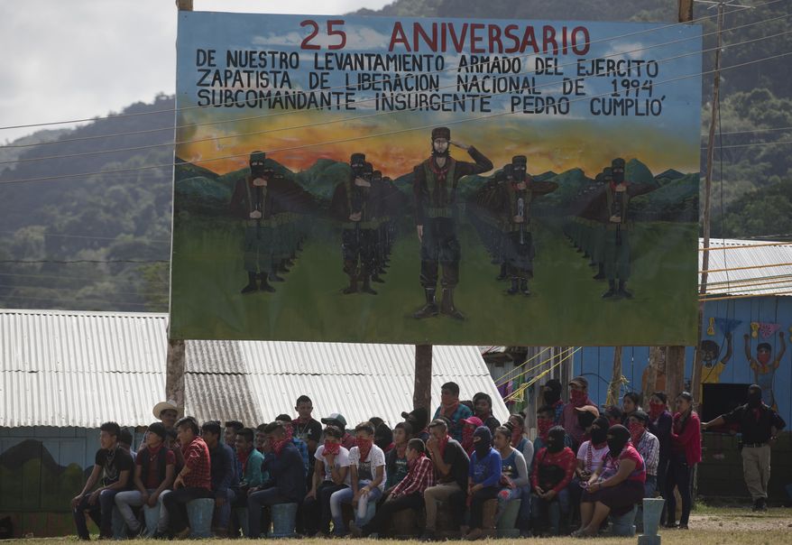FILE - In this Jan. 1, 2019 file photo, members of the Zapatista National Liberation Army, EZLN, attend an event marking the 25th anniversary of the Zapatista uprising in La Realidad, Chiapas, Mexico. The Zapatista indigenous rebel group posted on their website Saturday, Aug. 17, 2019, that it is extending its control over so-called “autonomous” zones to 11 more areas in the southern state of Chiapas. (AP Photo/Eduardo Verdugo)