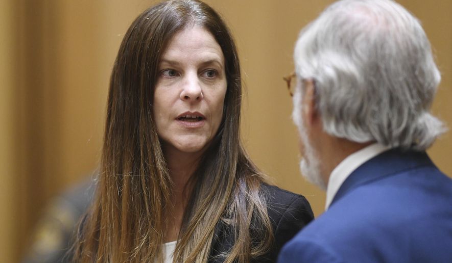 Michelle C. Troconis, 44, appears in court with her attorney Andrew Bowman in relation to her charges of tampering with or fabricating physical evidence and first-degree hindering prosecution, to which she has pleaded not guilty, at Connecticut Superior Court in Stamford, Conn. Monday, Aug. 19, 2019. The charges stem from video surveillance footage that police said shows two people resembling Troconis and Fotis Dulos making more than 30 stops in a four-mile stretch of Hartford the night of the disappearance of Dulos' wife, Jennifer. Police said the videos showed Fotis Dulos dumping bags that were later determined to contain clothing and cleaning supplies with his wife's blood, according to an arrest warrant. (Tyler Sizemore/Hearst Connecticut Media via AP, Pool)
