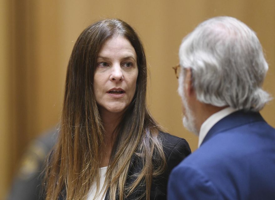 Michelle C. Troconis, 44, appears in court with her attorney Andrew Bowman in relation to her charges of tampering with or fabricating physical evidence and first-degree hindering prosecution, to which she has pleaded not guilty, at Connecticut Superior Court in Stamford, Conn. Monday, Aug. 19, 2019. The charges stem from video surveillance footage that police said shows two people resembling Troconis and Fotis Dulos making more than 30 stops in a four-mile stretch of Hartford the night of the disappearance of Dulos' wife, Jennifer. Police said the videos showed Fotis Dulos dumping bags that were later determined to contain clothing and cleaning supplies with his wife's blood, according to an arrest warrant. (Tyler Sizemore/Hearst Connecticut Media via AP, Pool)