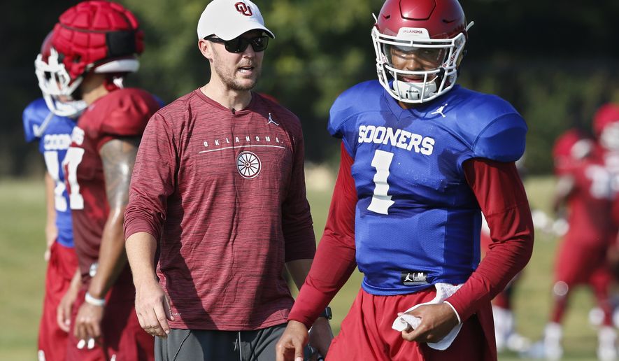 FILE - In this Monday, Aug. 5, 2019 file photo, Oklahoma head coach Lincoln Riley watches quarterback Jalen Hurts (1) during an NCAA college football practice in Norman, Okla. Oklahoma quarterback Jalen Hurts is cramming as he prepares for his only year with the Sooners. Before transferring from Alabama, he played in three national title games. (AP Photo/Sue Ogrocki, File)