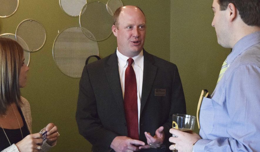 FILE - In this April 17, 2018, file photo, then-lieutenant governor candidate Will Ainsworth, center, meets with voters before he speaks at a forum in Montgomery, Ala. On Monday, Aug. 19, 2019, Ainsworth voiced opposition to a proposed toll bridge in south Alabama, saying it will be a burden on the region's working families. (AP Photo/Mallory Moench, File)