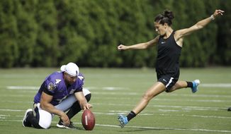Baltimore Ravens&#x27; Sam Koch holds the ball for United States soccer player Carli Lloyd as she attempts to kick a field goal after the Philadelphia Eagles and the Baltimore Ravens held a joint NFL football practice in Philadelphia, Tuesday, Aug. 20, 2019. (AP Photo/Matt Rourke) ** FILE **