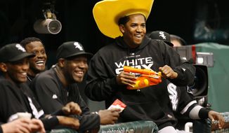 FILE - In this May 31, 2008 file photo, Chicago White Sox pitcher Octavio Dotel, in the cowboy hat, has fun with the Tampa Bay Rays&#x27; mascot, during a water pistol fight in a country night promotion prior to a baseball game, in St. Petersburg, Fla. Authorities in the Dominican Republic arrested on Tuesday, Aug. 20, 2019, the former MLB pitcher and are searching for ex-infielder Luis Castillo for their alleged links to a drug-trafficking and money-laundering ring in the Caribbean and United States. (AP Photo/Mike Carlson, File)