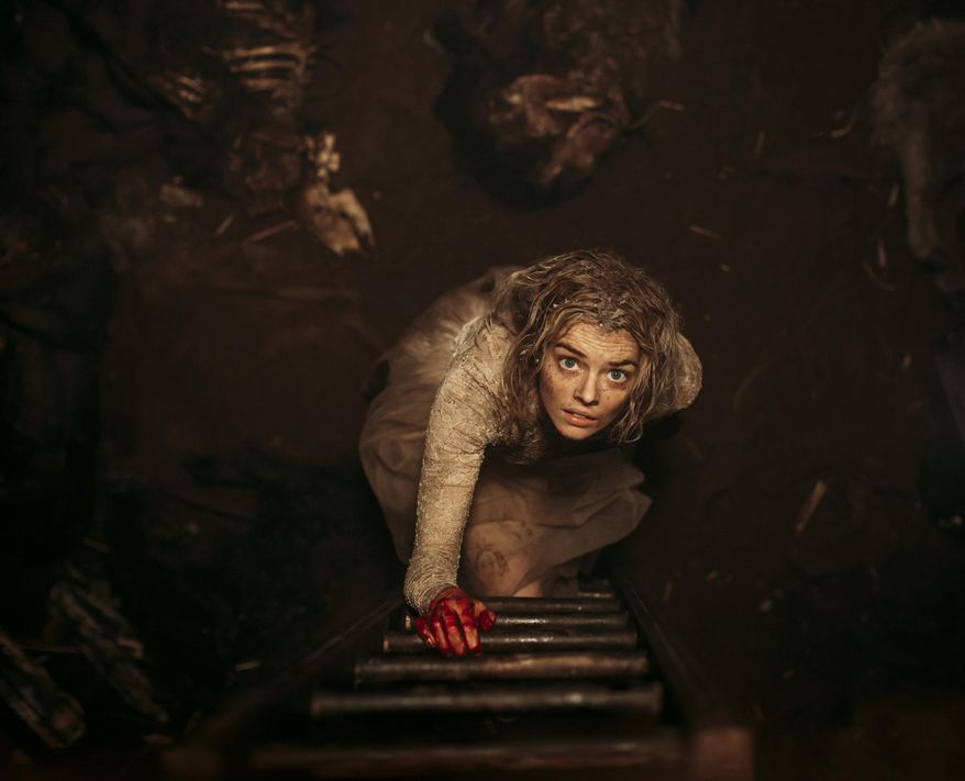 This image provided by Fox Searchlight Pictures shows Samara Weaving in the horror film “Ready or Not.” Weaving plays a bride who tries to stay alive until dawn on her wedding day as her in-laws hunt her down and try to kill her. (Eric Zachanowich/Fox Searchlight Pictures via AP)