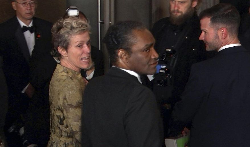 FILE - This March 4, 2018 file image taken from video shows Oscar winner Frances McDormand, foreground left, walking into the Governors Ball next to Terry Bryant, center, the man accused of stealing her Academy Award in Los Angeles. McDormand won the best actress category for her role in "Three Billboards Outside Ebbing, Missouri." On the day his trial was to begin, charges against Bryant have been dropped. Los Angeles County prosecutors said in court Tuesday, Aug. 20, 2019 that they were unable to proceed with the case against him, and a judge granted a defense motion to dismiss it. (AP Photo/Jeff Turner, file)