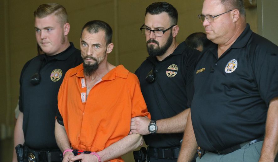FILE - In this Thursday, April 20, 2017 file photo, Nathan LeForce is taken into the Logan County Courthouse for his arraignment in Guthrie, Okla. A jury has begun deliberating a verdict in the trial of the man accused of shooting an Oklahoma sheriff's deputy to death. Deliberations began Tuesday, Aug. 20, 2019 in the LeForce's trial, who is charged with first-degree murder in the April 18, 2017, shooting of 40-year-old Logan County Deputy David Wade. (Steve Gooch/The Oklahoman via AP, File)