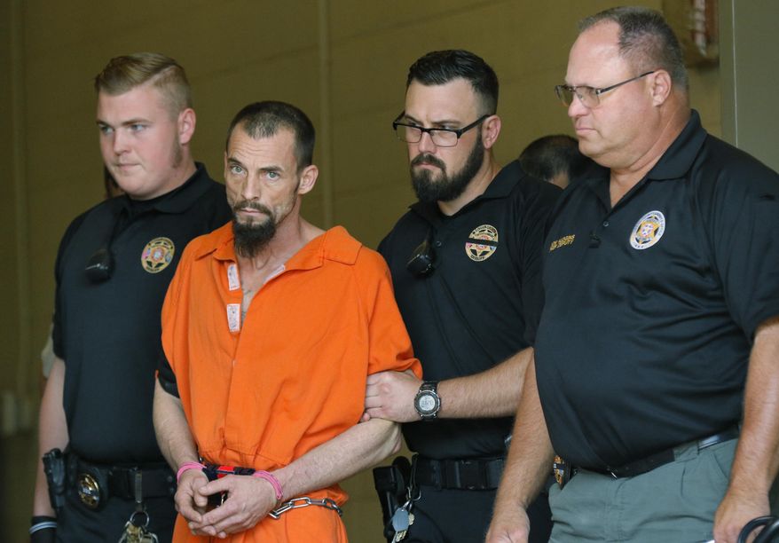 FILE - In this Thursday, April 20, 2017 file photo, Nathan LeForce is taken into the Logan County Courthouse for his arraignment in Guthrie, Okla. A jury has begun deliberating a verdict in the trial of the man accused of shooting an Oklahoma sheriff's deputy to death. Deliberations began Tuesday, Aug. 20, 2019 in the LeForce's trial, who is charged with first-degree murder in the April 18, 2017, shooting of 40-year-old Logan County Deputy David Wade. (Steve Gooch/The Oklahoman via AP, File)