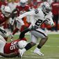 FILE - In this Aug. 15, 2019, file photo, Oakland Raiders running back Josh Jacobs (28) runs against the Arizona Cardinals during the first half of an an NFL football game in Glendale, Ariz. Once the regular season starts, the Raiders are hoping Jacobs can be the three-down featured back that has been missing of late on Oakland&#39;s offense. (AP Photo/Rick Scuteri, File)