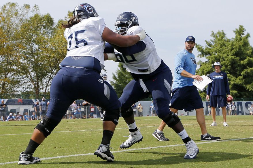 FILE - In this July 30, 2018, file photo, Tennessee Titans offensive guards Xavier Su'a-Filo (76) and Kevin Pamphile (66) run a drill during NFL football training camp in Nashville, Tenn. Pamphile says this is the first training camp he's seen coaches switching up along the offensive line, and the Tennessee Titans are letting the competition continue into the third week of the preseason. (AP Photo/Mark Humphrey, File)