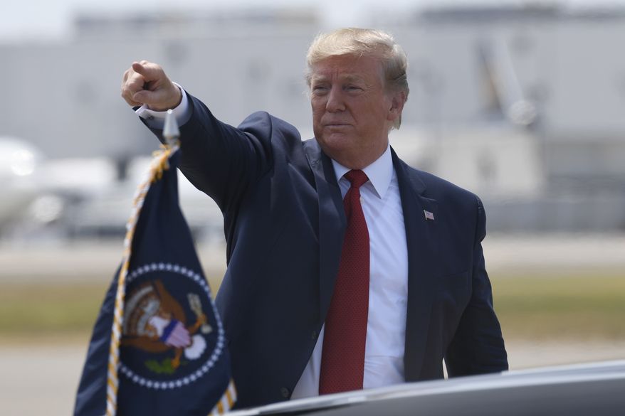 President Donald Trump points to the crowd after arriving on Air Force One at Louisville International Airport in Louisville, Ky., Wednesday, Aug. 21, 2019. Trump is in town to speak at the American Veterans (AMVETS) 75th National Convention. (AP Photo/Susan Walsh)