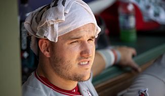 Los Angeles Angels&#39; Mike Trout cools off in the dugout during the third inning of the first baseball game of a doubleheader against the Texas Rangers Tuesday, Aug. 20, 2019, in Arlington, Texas. Los Angeles won 5-1 as temperatures topped 100 degrees Fahrenheit. (AP Photo/Jeffrey McWhorter)