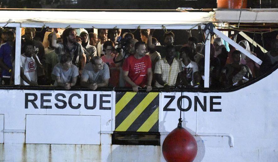 The Open Arms rescue ship arrives on the Sicilian island of Lampedusa, southern Italy, Tuesday, Aug. 20, 2019. Italian prosecutor Luigi Patronaggio has ordered the seizure of a migrant rescue ship and the immediate evacuation of more than 80 migrants remaining on board, capping dramatic developments that saw 15 migrants jump into the sea in a desperate bid to reach land and the Spanish government dispatch a Naval ship on a long journey to resolve the escalating crisis. (AP Photo/Salvatore Cavalli)