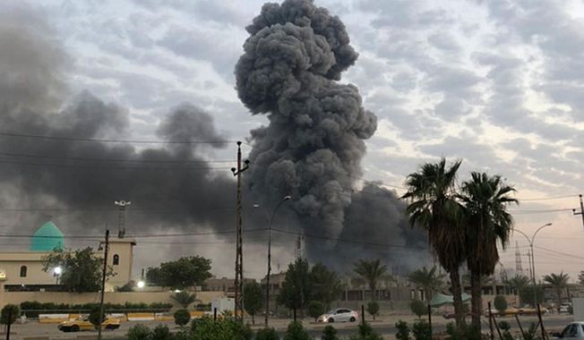 In this Monday, Aug. 12, 2019, file photo, plumes of smoke rise after an explosion at a military base southwest of Baghdad, Iraq. A fact-finding committee appointed by the Iraqi government to investigate a massive munitions depot explosion near the capital Baghdad has concluded that the blast was the result of a drone strike. A copy of the report was obtained by The Associated Press Wednesday, Aug. 21, 2019. (AP Photo/Loay Hameed, File)