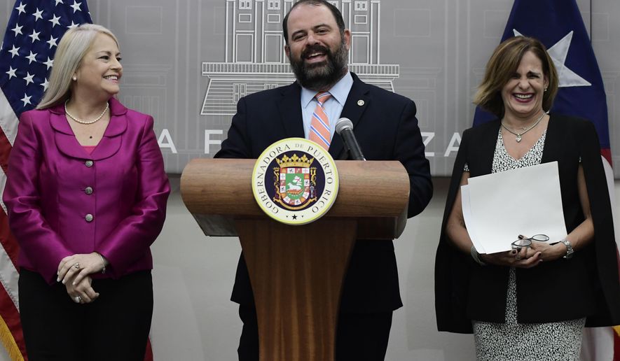 Puerto Rico's Governor Wanda Vazquez, holds a press conference where she announces the appointments of Eli Diaz Atienza, center, and Zoe Laboy, right, at the governor's official residence La Fortaleza in San Juan, Puerto Rico, Wednesday, Aug. 21, 2019. Vazquez appointed Senator Zoe Laboy as Chief of Staff, and the Executive Director of the Aqueduct and Sewer Authority Eli Diaz Atienza as representative on the Federal Board of Fiscal Control. (AP Photo/Carlos Giusti)