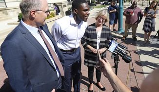 Wisconsin Badger football player Quintez Cephus speaks during a press conference outside the Madison Municipal Building addressing his reinstatement to the university in Madison, Wis. Monday, Aug. 19, 2019. He is pictured with his attorneys, Stephen Meyer and Kathleen Stilling. The university expelled Cephus last semester for violating the non-academic misconduct code following accusations of sexual assault from two women. A Dane County jury acquitted him of those charges earlier this month after deliberating for less than an hour. (John Hart/Wisconsin State Journal via AP)