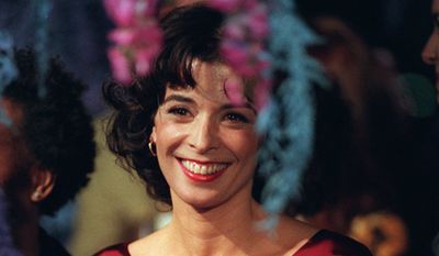 Actress Annabella Sciorra, one of the stars of the new Polygram film, &quot;What Dreams May Come,&quot; with Robin Williams and Cuba Gooding Jr., is photographed through floral decorations at the premiere of the film, Monday, Sept. 28, 1998, at the Academy of Motion Picture Arts &amp; Sciences in Beverly Hills, Calif.  (AP Photo/Chris PIzzello) ** FILE **