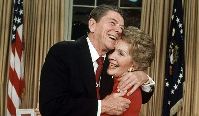 President Ronald Reagan embraces first lady Nancy Reagan on Jan. 30, 1984, in Washington, after he announced that he will run for a second term as President. Reagan, 72, confirmed that Vice President George Bush will again be his running mate in a campaign already well underway. (AP Photo/Ira Schwarz) ** FILE **