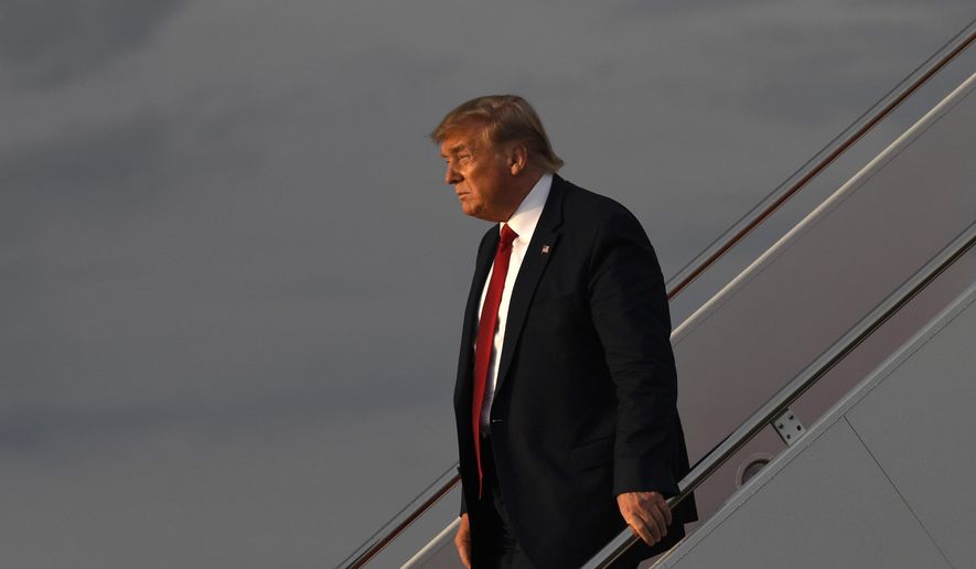 In this Aug. 21, 2019, file photo, President Donald Trump walks down the steps of Air Force One at Andrews Air Force Base in Md. (AP Photo/Susan Walsh)