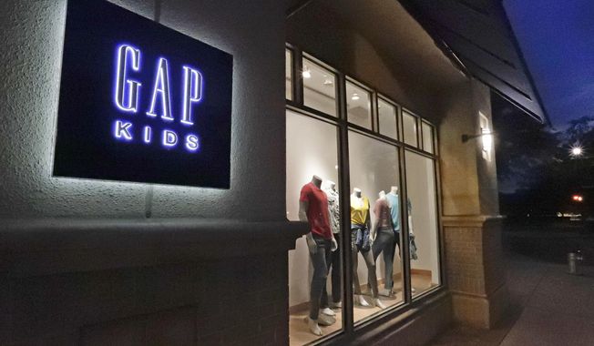 FILE - This Aug. 23, 2018, file photo shows a window display at a Gap Kids clothing store in Winter Park, Fla. The Gap Inc. reports financial results Thursday, Aug. 22. (AP Photo/John Raoux, File)