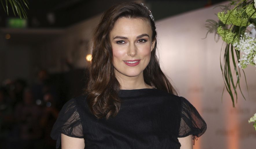 FILE - In this Monday, Feb. 18, 2019, file photo, actress Keira Knightley poses for photographers upon arrival at the premiere of the film "The Aftermath" in London. Knightley says she wanted to accurately portray the actions of Iraq War whistleblower Katharine Gun in “Official Secrets,” which arrives in U.S. theaters on Aug. 30, 2019, but her performance was complicated somewhat by her decision to have her daughter transition from her baby bed during filming. (Photo by Joel C Ryan/Invision/AP, File)