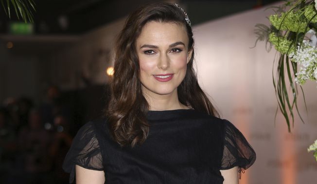 FILE - In this Monday, Feb. 18, 2019, file photo, actress Keira Knightley poses for photographers upon arrival at the premiere of the film "The Aftermath" in London. Knightley says she wanted to accurately portray the actions of Iraq War whistleblower Katharine Gun in “Official Secrets,” which arrives in U.S. theaters on Aug. 30, 2019, but her performance was complicated somewhat by her decision to have her daughter transition from her baby bed during filming. (Photo by Joel C Ryan/Invision/AP, File)