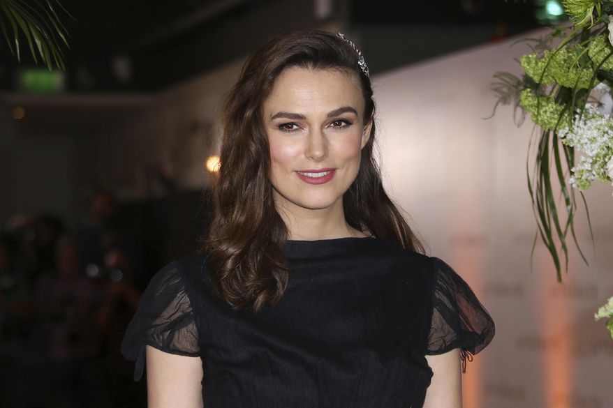 FILE - In this Monday, Feb. 18, 2019, file photo, actress Keira Knightley poses for photographers upon arrival at the premiere of the film "The Aftermath" in London. Knightley says she wanted to accurately portray the actions of Iraq War whistleblower Katharine Gun in “Official Secrets,” which arrives in U.S. theaters on Aug. 30, 2019, but her performance was complicated somewhat by her decision to have her daughter transition from her baby bed during filming. (Photo by Joel C Ryan/Invision/AP, File)