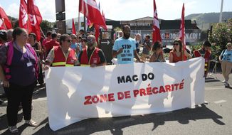 Unionists demonstrate with a banner reading &amp;quot;Mac Do, social insecurity zone&amp;quot; in front of a McDonald&#39;s restaurant, Thursday, Aug. 22, 2019 in Hendaye, southwestern France. The G-7 summit has for the first time co-opted the message of its protesters: Capitalism has led to damaging inequality, hurting the environment also harms the global economy, and a handful of rich countries can&#39;t be the only ones making decisions for the world. (AP Photo/Bob Edme)