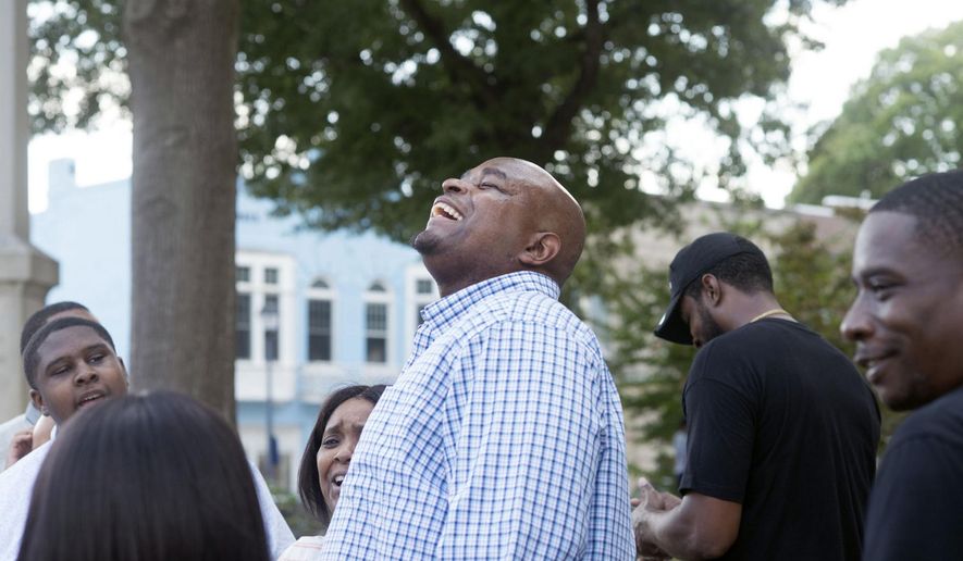 Dontae Sharpe breathes the air outside the Pitt County Courthouse after a judge determined he could be set free, Thursday, Aug. 22, 2019 in Greenville, N.C. Sharpe, a North Carolina man who maintained his innocence even as he served a life sentence for a murder he didn’t commit said Thursday that he got his strength in prison from God and his mother. (Deborah Griffin/The Daily Reflector via AP)