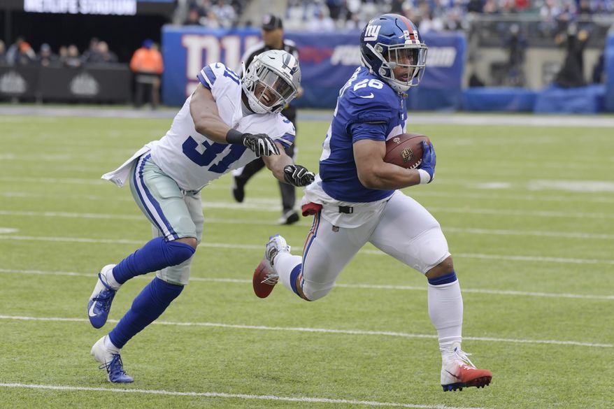 FILE - In this Dec. 30, 2018, file photo, Dallas Cowboys' Byron Jones, left, tries to catch New York Giants' Saquon Barkley during the first half of an NFL football game in East Rutherford, N.J. The dynamic second-year running back is worth the price of admission and can help the team pull off upsets by himself. (AP Photo/Bill Kostroun, File)
