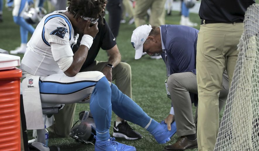 Carolina Panthers quarterback Cam Newton (1) receives attention on the sideline after an injury in the first half of an NFL preseason football game against the New England Patriots, Thursday, Aug. 22, 2019, in Foxborough, Mass. (AP Photo/Charles Krupa)