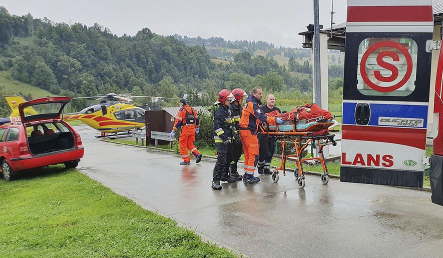 Rescue helicopter and ambulance have brought to hospital the first people injured by a lighting strike that struck in Poland's southern Tatra Mountains during a sudden thunderstorm, in Zakopane, Poland, on Thursday, Aug. 22, 2019.(AP Photo/Bartlomiej Jurecki)